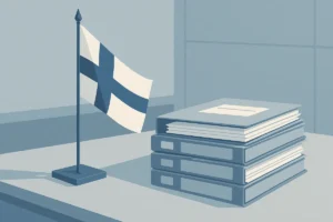 Finnish flag next to a stack of gambling licence application documents on a regulator's desk